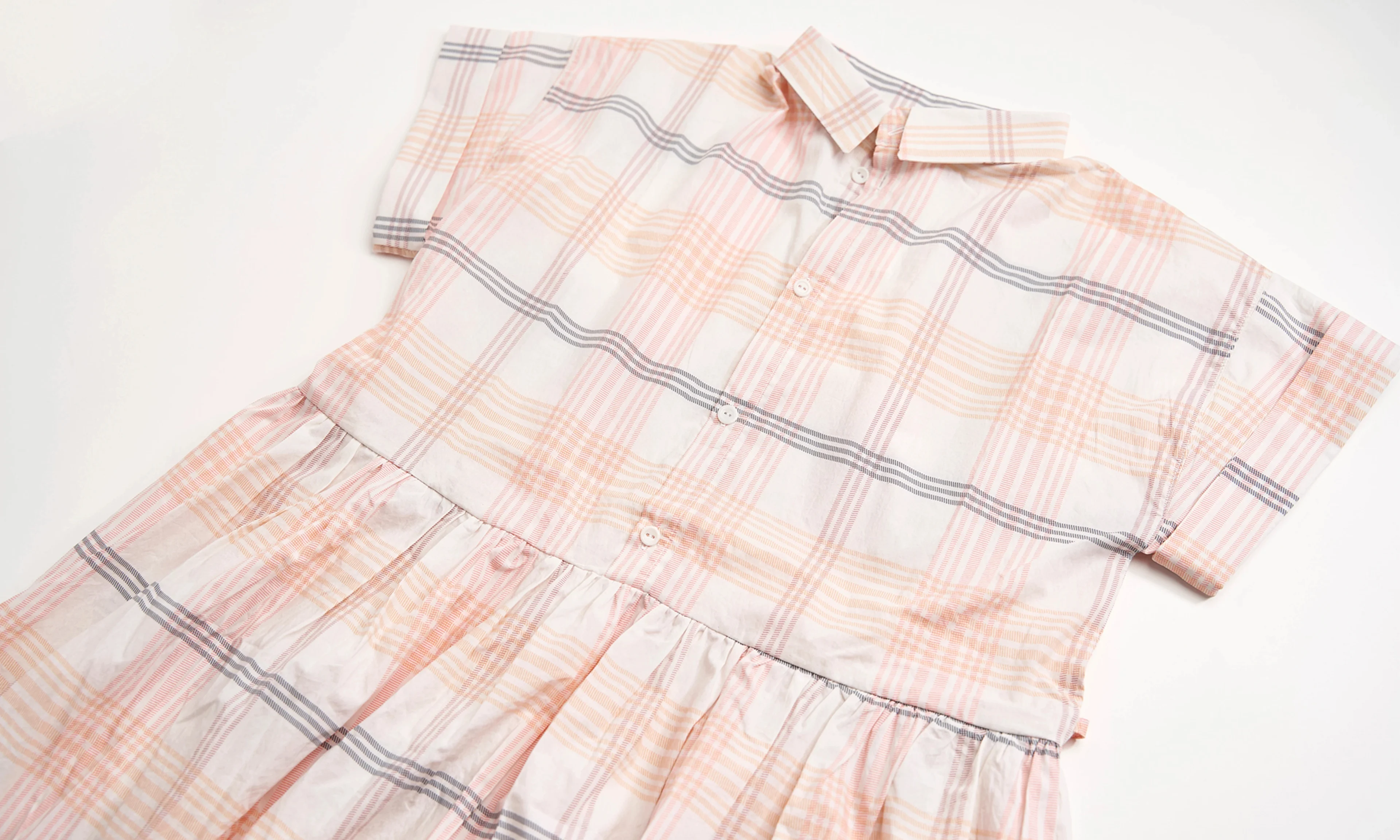 Plaid dress laying out.