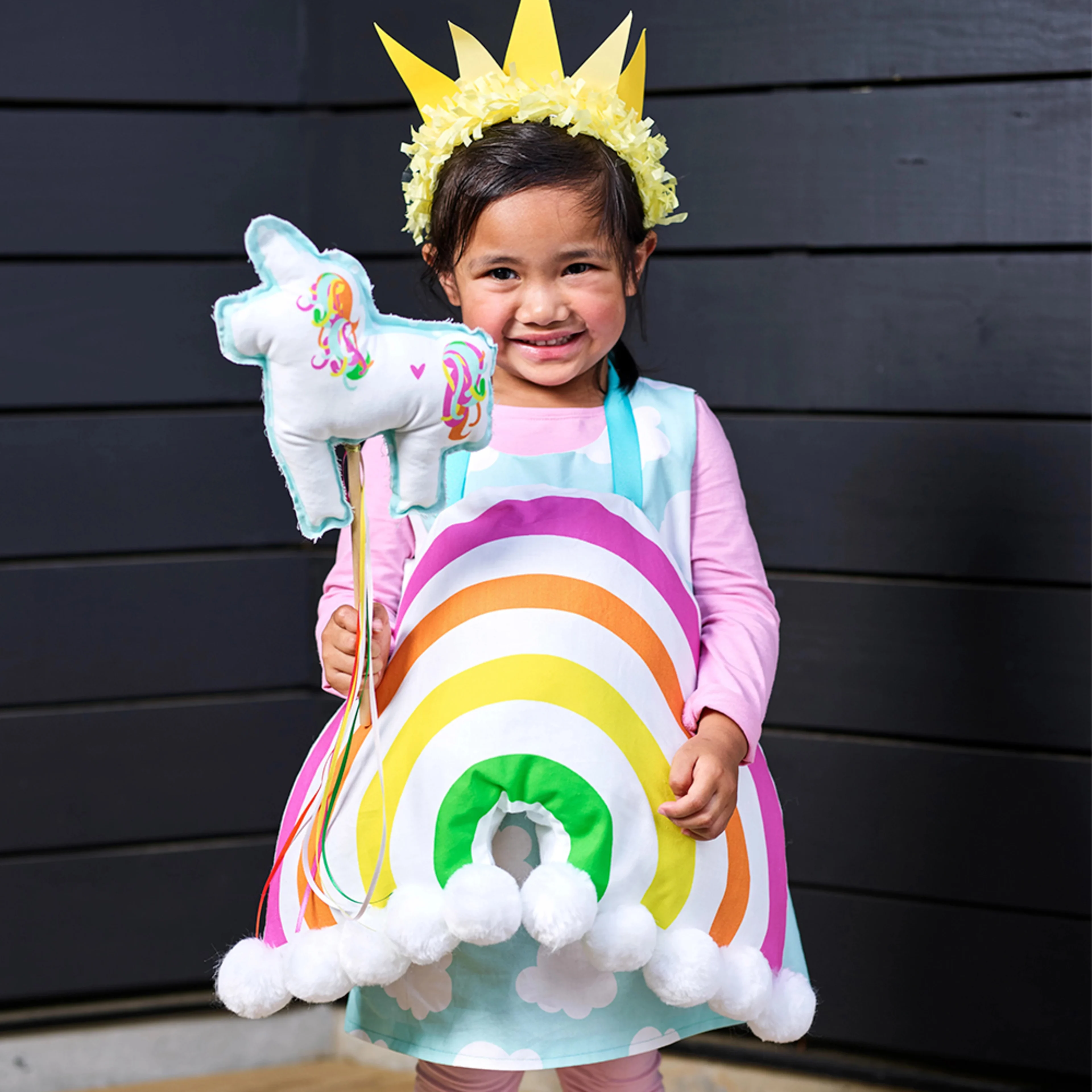 Little girl in a rainbow costume.