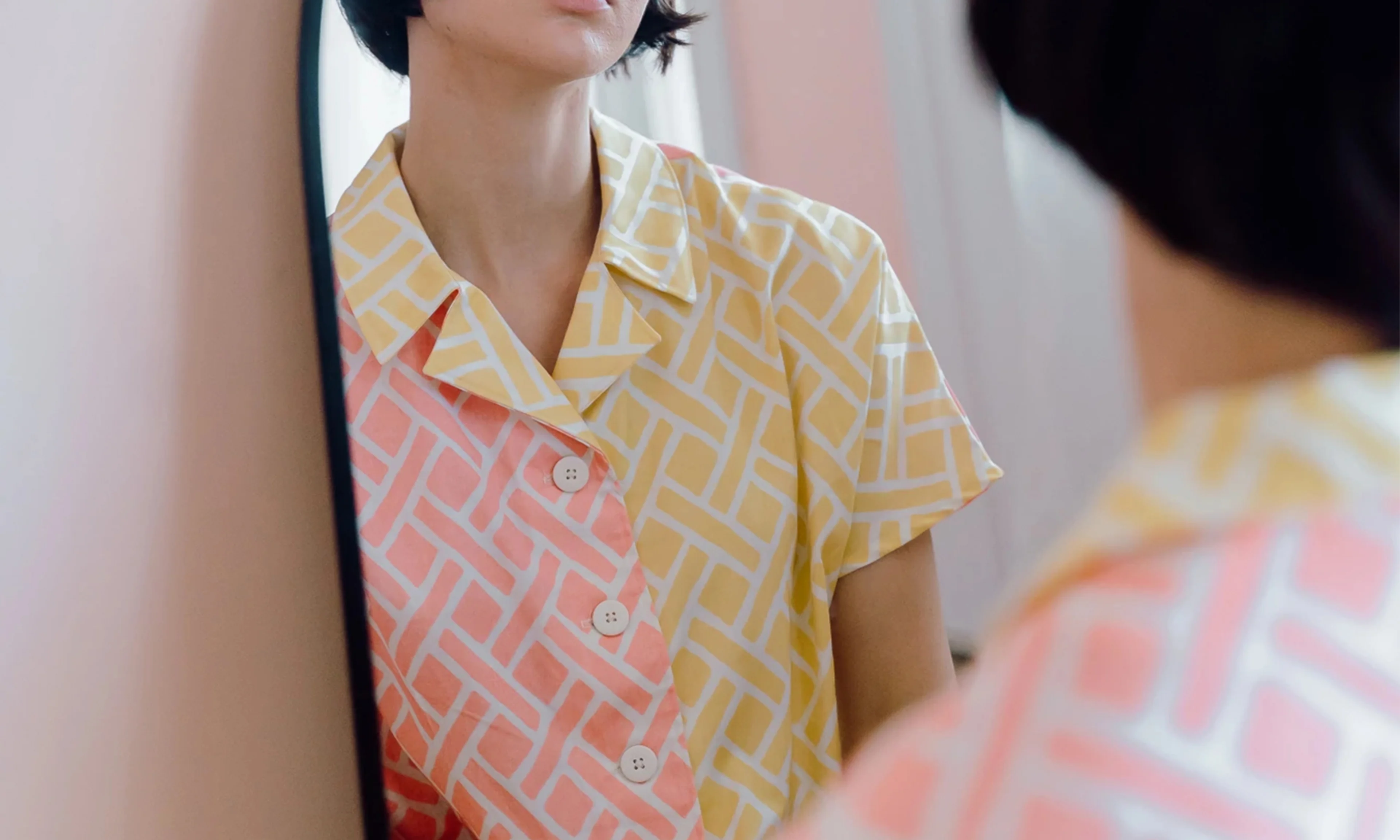 Woman wearing a button down shirt made with Spoonflower fabrics.