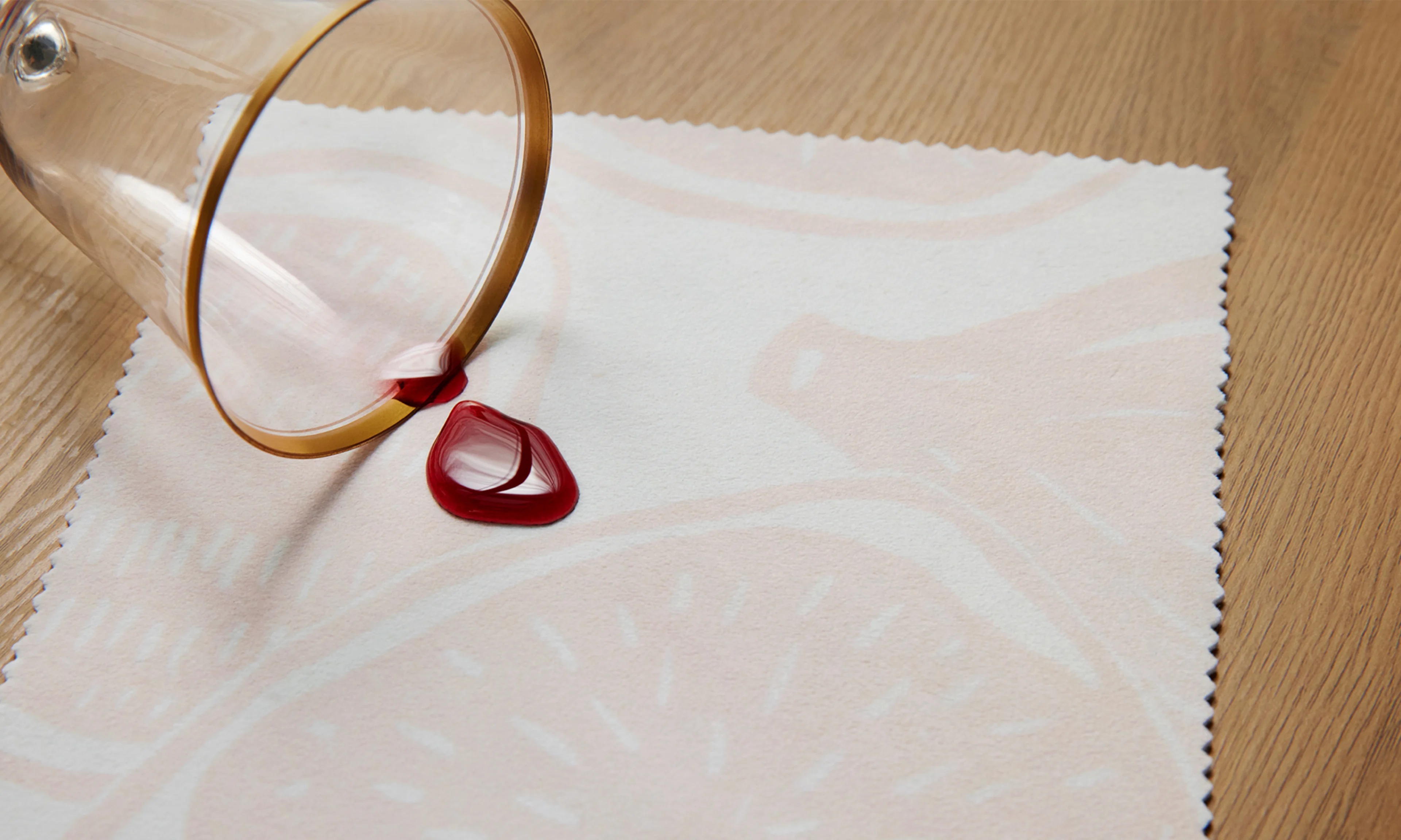 Red wine spilling onto Spoonflower performance velvet